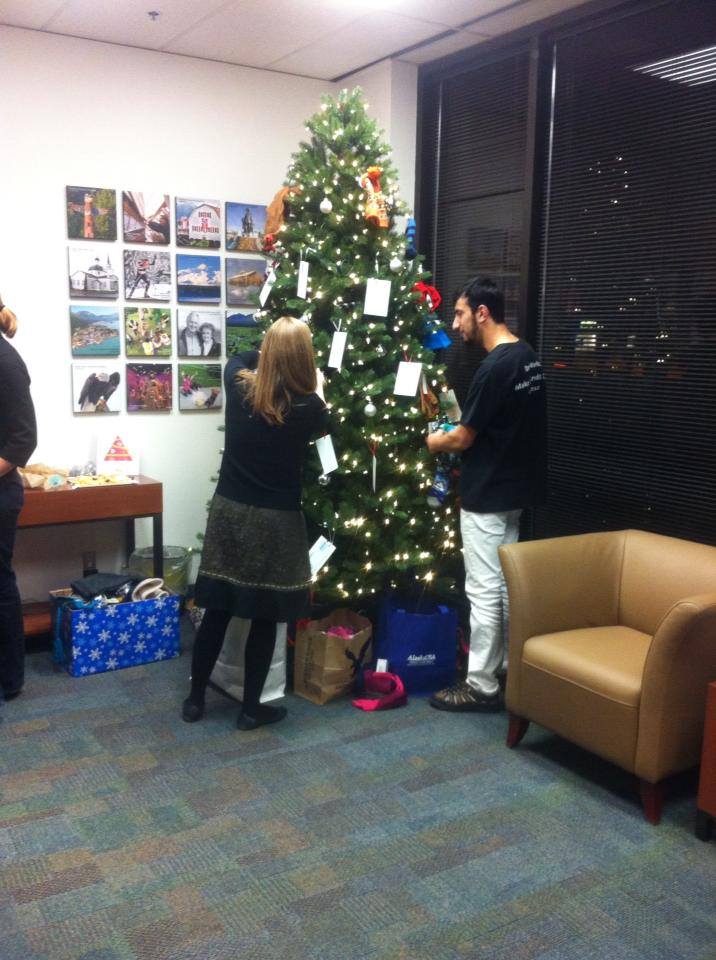 An image of ACF staff and volunteers collecting hats and mittens from our holiday giving tree.